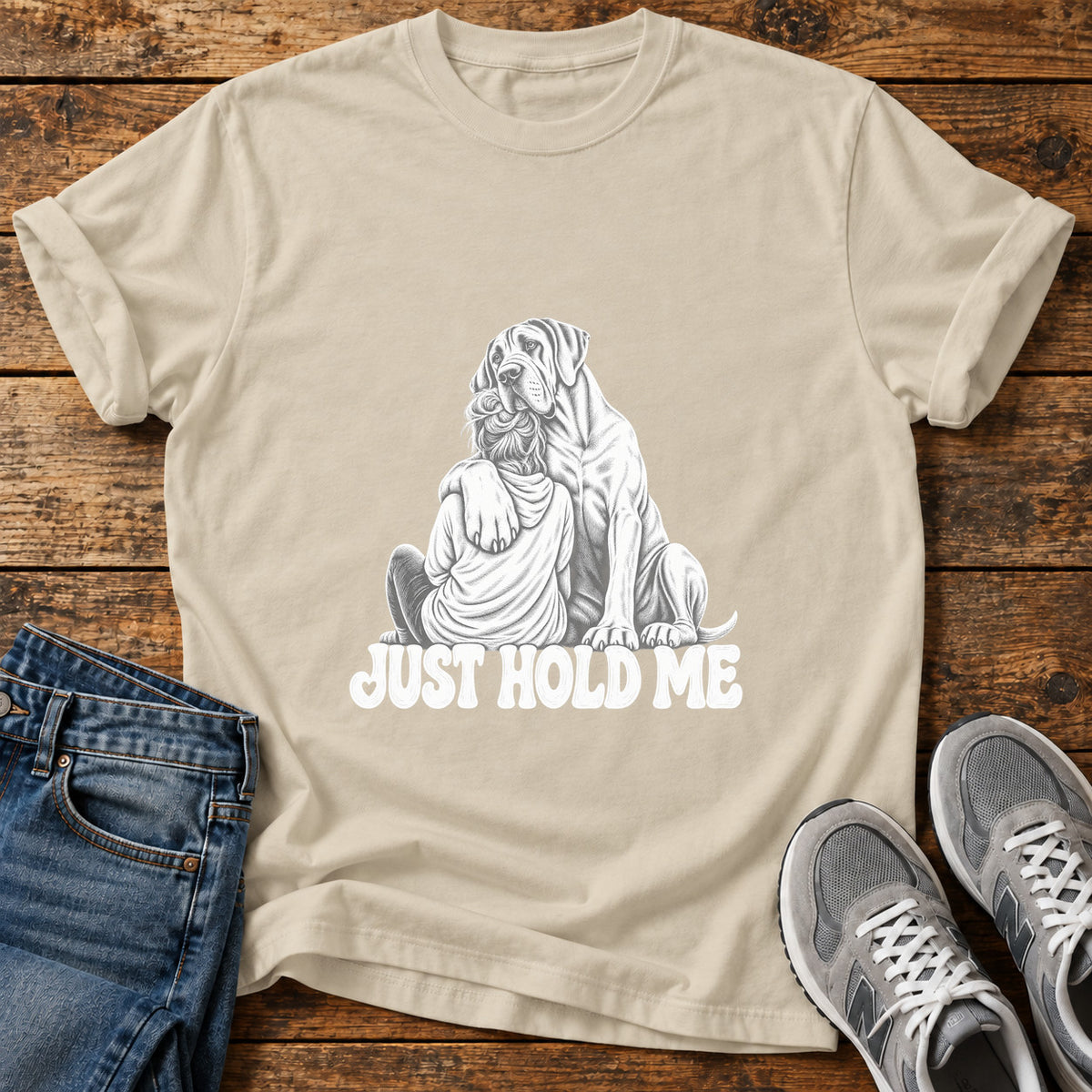 Just Hold Me Great Dane graphic T-shirt in Sand, shown on a flat-lay shirt mockup
