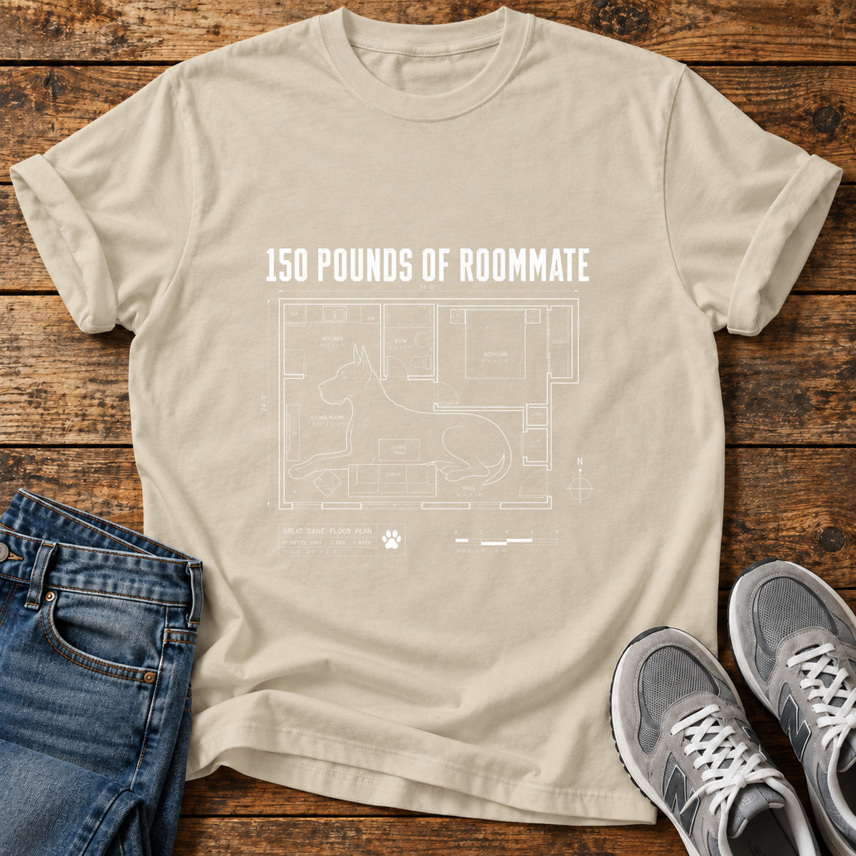 150 Pounds Roommate Great Dane graphic T-shirt in Sand, shown on a flat-lay shirt mockup
