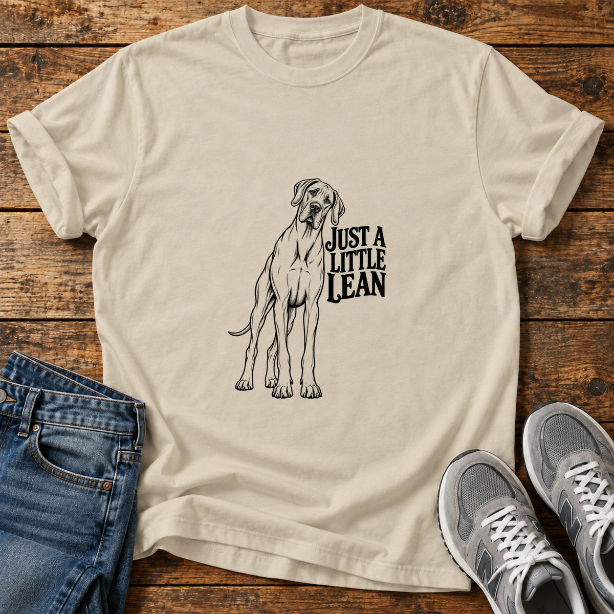 Just A Lean Great Dane graphic T-shirt in Sand, shown on a flat-lay shirt mockup