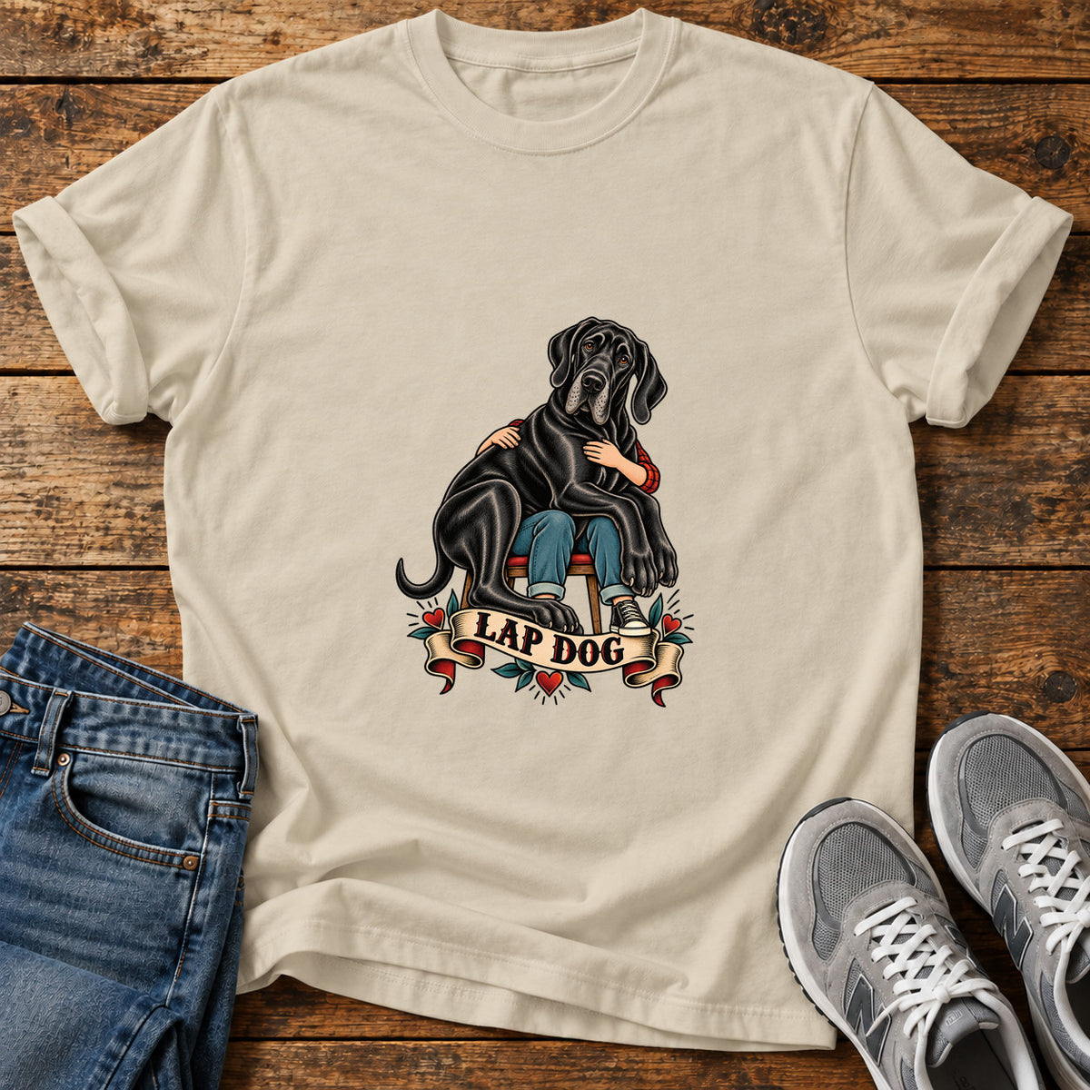 Lap Dog Great Dane graphic T-shirt in Sand, shown on a flat-lay shirt mockup