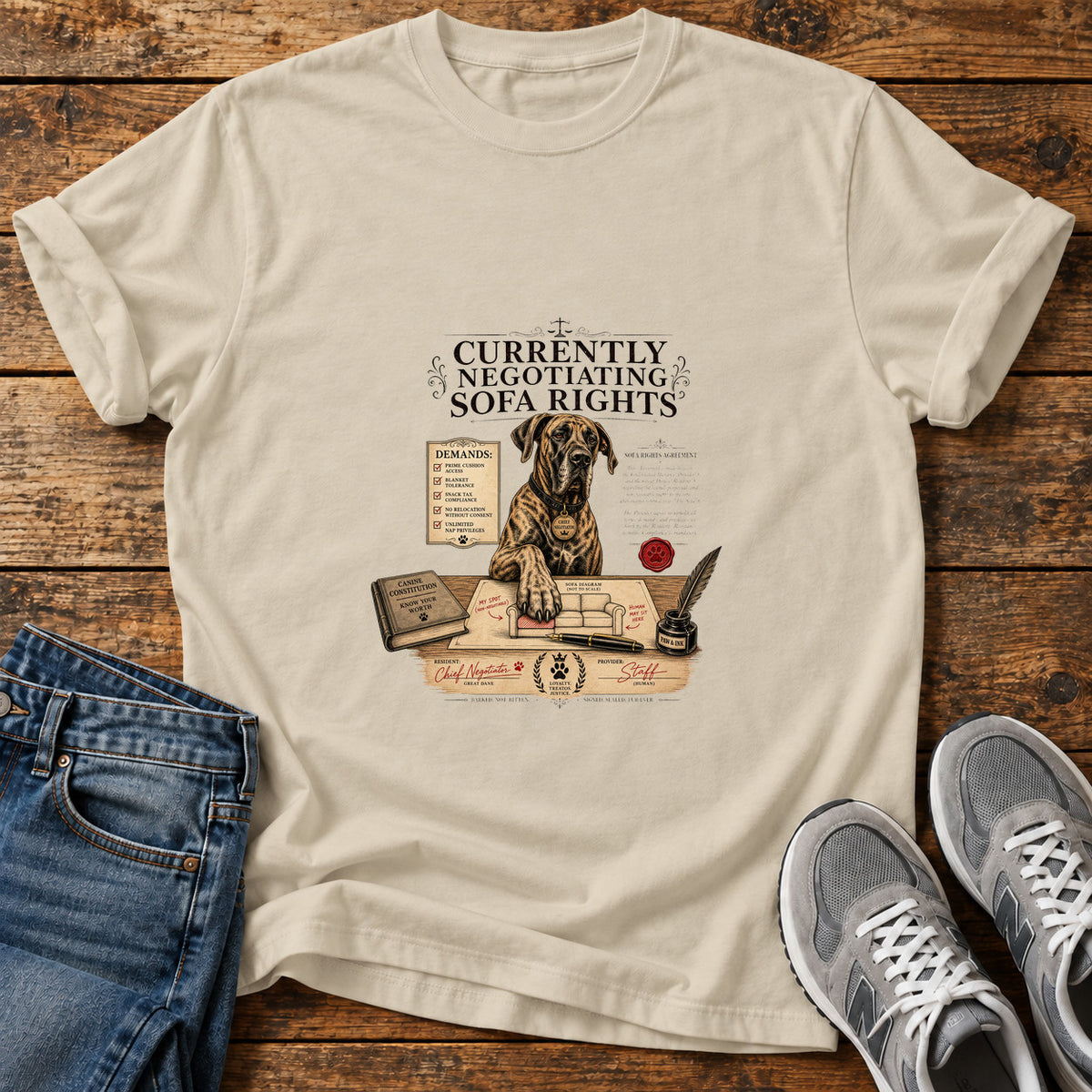 Sofa Rights Negotiation Great Dane graphic T-shirt in Sand, shown on a flat-lay shirt mockup