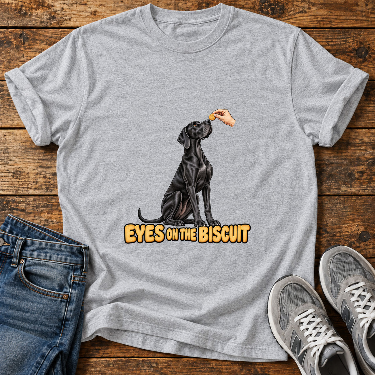 Eyes on Biscuit Great Dane graphic T-shirt in Sport Grey, shown on a flat-lay shirt mockup