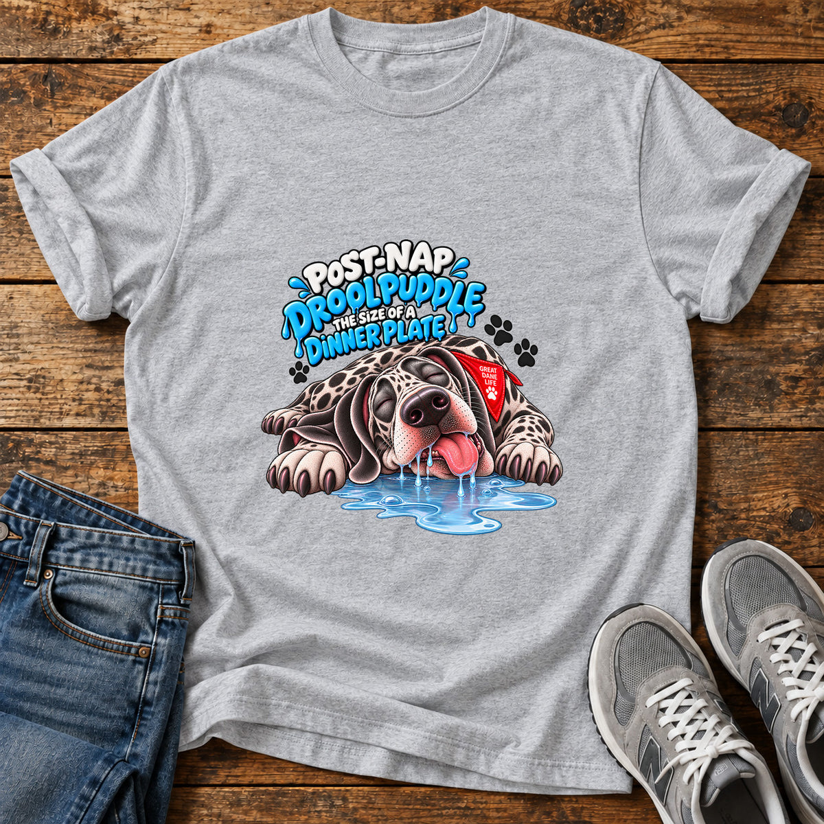 Drool Puddle Delight Great Dane graphic T-shirt in Sport Grey, shown on a flat-lay shirt mockup