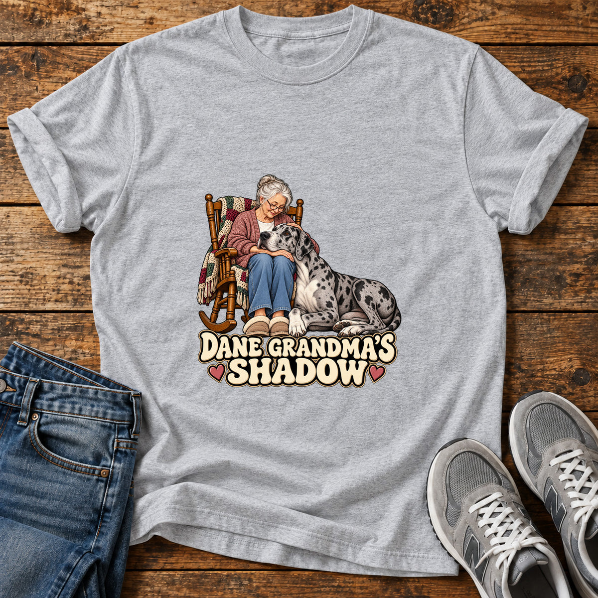 Dane Grandma's Shadow Great Dane graphic T-shirt in Sport Grey, shown on a flat-lay shirt mockup