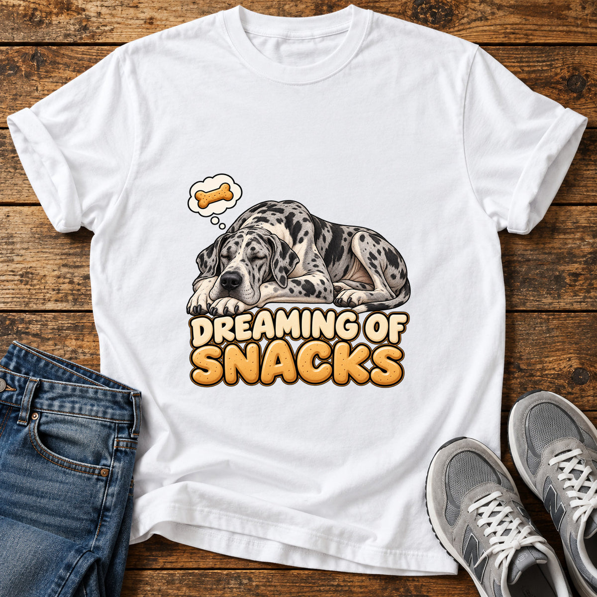 Dreaming Snacks Great Dane graphic T-shirt in White, shown on a flat-lay shirt mockup