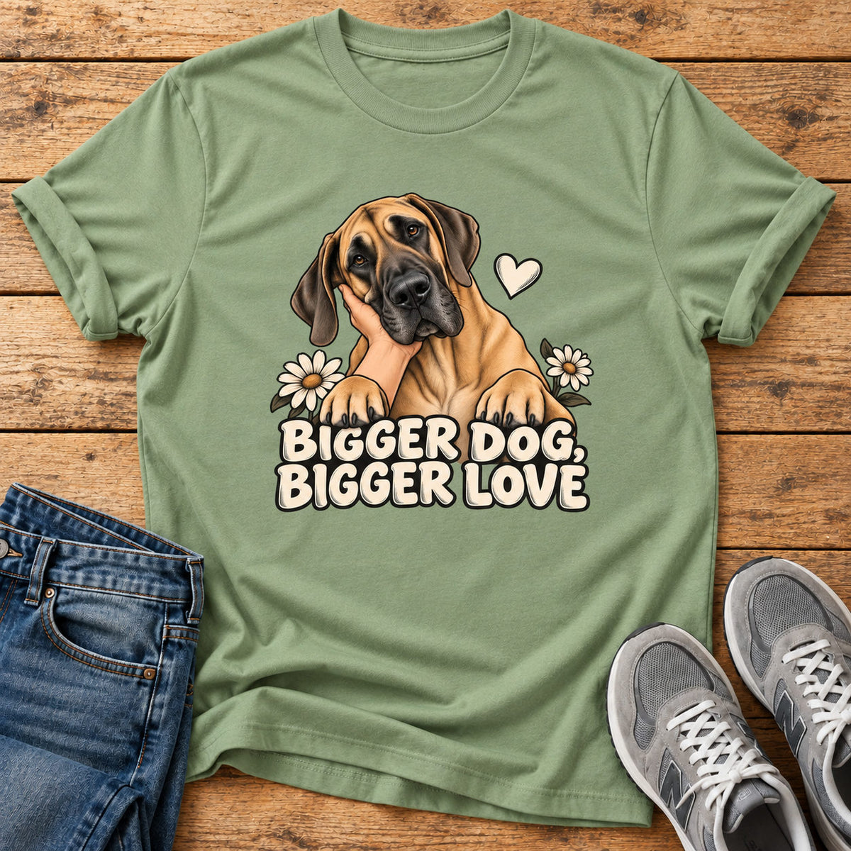 Bigger Love T-shirt on a light wood flat lay with jeans and walking shoes